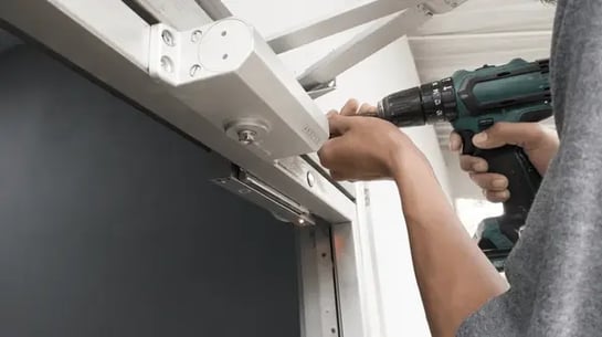 man-installing-magnetic-lock-system-600nw-2216189563